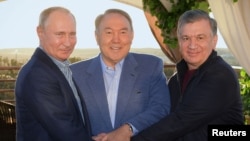FILE - Russian President Vladimir Putin, left, Kazakh President Nursultan Nazarbayev, center, and Uzbek President Shavkat Mirziyoyev meet in Saryagash, Southern Kazakhstan, Oct. 20, 2018.