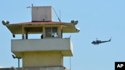 A police helicopter flies over the state prison in Acapulco, Mexico, July 6, 2017.