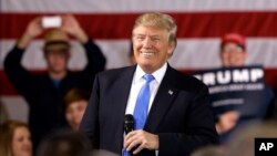 FILE - Republican presidential candidate Donald Trump smiles as he speaks at a campaign stop Tuesday, March 29, 2016.