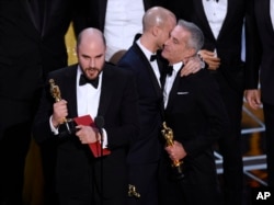 Jordan Horowitz, left, of "La La Land," mistakenly accepts the award for best picture at the Oscars on Sunday, Feb. 26, 2017, at the Dolby Theatre in Los Angeles. It was later determined that "Moonlight," won best picture.