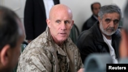 Vice Adm. Robert S. Harward, commanding officer of Combined Joint Interagency Task Force 435, speaks to an Afghan official during his visit to Zaranj, Afghanistan, in this Jan. 6, 2011, handout photo. 