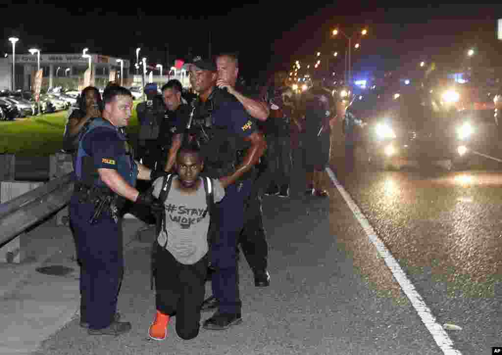 Police arrest activist DeRay McKesson during a protest along Airline Highway, a major road that passes in front of the Baton Rouge Police Department headquarters in Baton Rouge, Louisana, July 9, 2016.&nbsp;Protesters angry over the fatal shooting of Alton Sterling by two white Baton Rouge police officers rallied at the convenience store where he was shot.