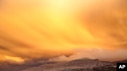 A view is seen of a cloud of ash from Chile's Puyehue-Cordon Caulle volcano chain near sunset at the mountain resort San Martin de Los Andes in Argentina's Patagonia June 12, 2011.