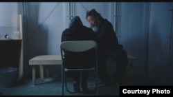 Ai Weiwei talks to refugee in scene from 'Human Flow' documentary.