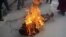 FILE - This still image allegedly shows the self-immolation of an individual along a street in Dawu, Ganzi prefecture in Sichuan province.