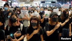 Anti-government protesters sing a protest song "Glory to Hong Kong" during a sit-in at Yoho mall, at Yuen Long MTR station, in Hong Kong, China September 21, 2019. REUTERS/Tyrone Siu 