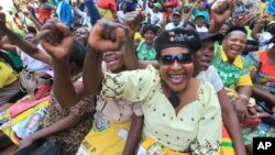FILE: Women chant party slogans upon the arrival of Zimbabwean President Robert Mugabe for a crucial Zanu PF Poltiburo meeting in Harare, Wednesday Feb. 10, 2016. Mugabe addressed thousand of party supporters and chaired a bitterly divided Zanu pf Politiburo amid heightened tensions over issues to do with factionalism and succession in the party.(AP Photo/Tsvangirayi Mukwazhi)