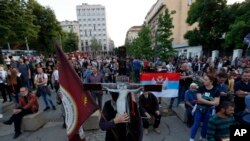 People attend a protest after arrest of the Serbian Orthodox Church priests in Montenegro, in Belgrade, Serbia, Thursday, May 14, 2020.