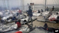 Detainees are seen in a Customs and Border Protection (CBP) temporary overflow facility in Donna, Texas, March 20, 2021, in this photo provided by the Office of Rep. Henry Cuellar, D-Texas.