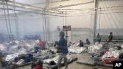 Detainees are seen in a Customs and Border Protection (CBP) temporary overflow facility in Donna, Texas, March 20, 2021, in this photo provided by the Office of Rep. Henry Cuellar, D-Texas.