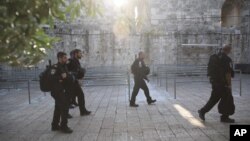 Israeli police officers walk outside the Al Aqsa Mosque compound in Jerusalem's Old City, July 25, 2017. 