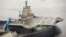 FILE - China's first aircraft carrier, which was renovated from an old aircraft carrier that China bought from Ukraine in 1998, is seen docked at Dalian Port, in Dalian, Liaoning province September 22, 2012. 