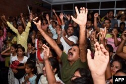 People celebrate the successful landing of Chandrayaan-3 spacecraft on the Moon, at Guwahati Planetarium in Guwahati on August 23, 2023. (Photo by Biju BORO / AFP)