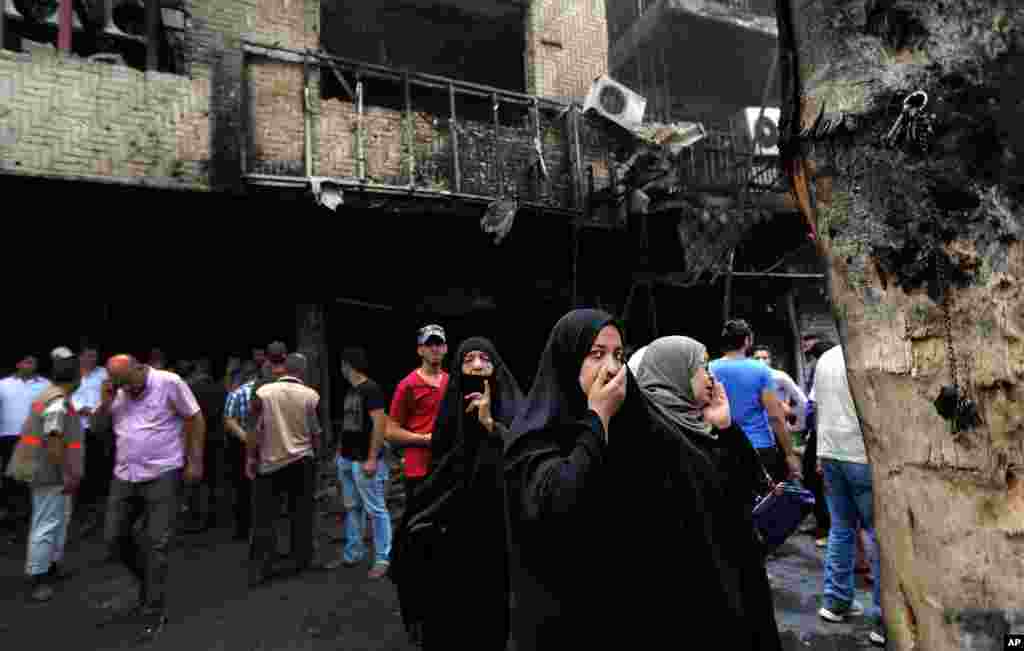 Women wait to hear about family members after a car bomb hit Karada, July 3, 2016.