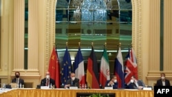 This handout photo released on May 1, 2021 by the EU Delegation in Vienna shows delegation members from the parties to the Iran nuclear deal attending a meeting at the Grand Hotel in Vienna.