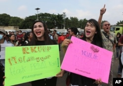 LGBT activists shout slogans during a rally against a planned revision to Indonesia's criminal code, outside the Parliament in Jakarta, Indonesia, Monday, Feb. 12, 2018.