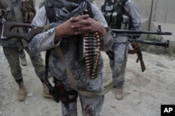 FILE - Afghan security forces guard a checkpoint in Spein Boldak at the border with Pakistan, Kandahar province, Afghanistan, Jan. 25, 2016.