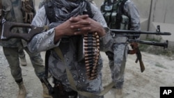 FILE - Afghan security forces guard a checkpoint in Spein Boldak at the border with Pakistan, Kandahar province, Afghanistan, Jan. 25, 2016, after three Taliban gunmen killed Afghan General Khan Agha in the Dand districty.