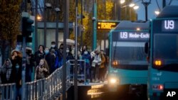 People wearing face masks arrive at a subway station in Frankfurt, Germany, Nov. 19, 2020. 