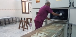 After the bombing of the detention center near Tripoli, authorities store bodies ahead of investigations, in Tripoli, Libya, July 2, 2019. (H. Murdock/VOA)