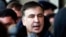 FILE - Former Georgian President Mikheil Saakashvili speaks with journalists near the Fairmont Grand Hotel in Kyiv, Ukraine, Feb. 9, 2018. Saakashvili claimed that unidentified armed people wearing military uniforms tried to arrest him inside the hotel.