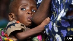 A Malawian child, suffering from HIV, breast-feeds at the Zomba NRU (Nutritional and Rehabilitation Unit), 60 kms south of Blantyre, October 14, 2005 file photo. 