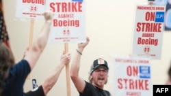 FILE - People react to an announcement that union members rejected a proposed Boeing contract and will go on strike, following voting results at their union hall in Seattle, Washington, on Sept. 12, 2024.