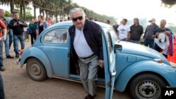 FILE - Uruguay's former President Jose Mujica arrives to cast his vote in Montevideo, Uruguay, Oct. 26, 2014.
