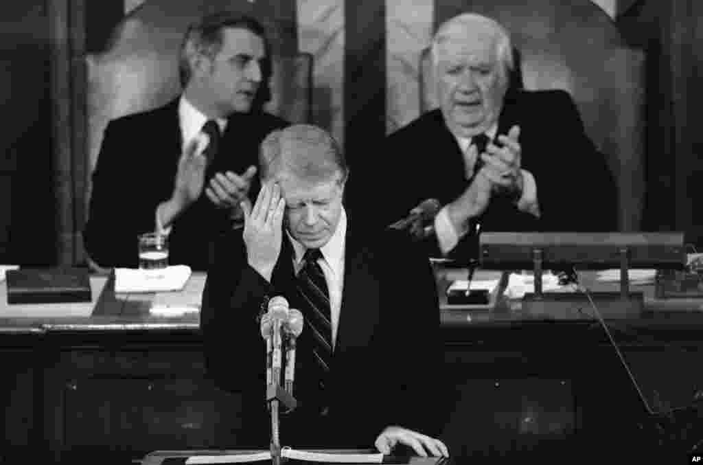 President Jimmy Carter touches his brow as he addresses those in the House chamber of the Capitol in Washington on Jan. 23, 1979.
