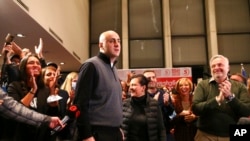 Nika Melia, head of the United National Movement, center, and his party supporters listen to the first results at the party headquarters after national municipal elections in Tbilisi, Georgia, Oct. 2, 2021. 