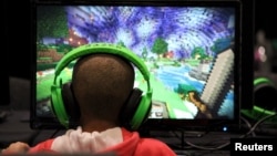 FILE - A child plays video game Minecraft in London, July 4, 2015.