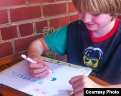 American elementary school student practicing Chinese