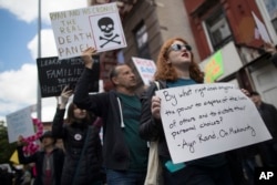 FILE - Protesters chant slogans outside the Success Academy charter school before House Speaker Paul Ryan, R-Wis., arrived, May 9, 2017, in the Harlem neighborhood of New York. Ryan was visiting the school, which is run by an advocate who was considered for the post of U.S. secretary of education.