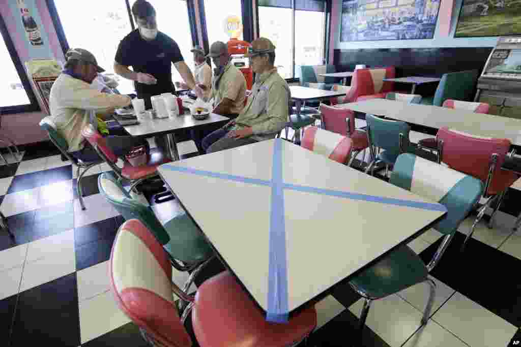 Tables are marked off for social distancing at Hwy 55 Burgers Shakes &amp; Fries Monday, April 27, 2020, in Nolensville, Tenn. (AP Photo/Mark Humphrey) 