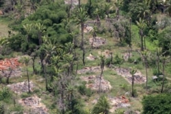 FILE - An aerial view shows burned villages once inhabited by the Rohingya, seen from the Myanmar military helicopters that carried U.N. envoys to northern Rakhine state, Myanmar, May 1, 2018.
