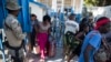 Haitians cross from the Dominican Republic into Malpasse, Haiti, March 17, 2020. Haitian authorities shutdown its border with the Dominican Republic on Monday as a precaution against the spread of the new coronavirus.