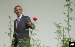 President Barack Obama walks along the Colonnade as he heads to the Oval Office of the White House in Washington, July 27, 2016.