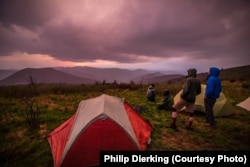 Hikers admiring a sunset from Black Balsam, a popular trail accessible directly from the Blue Ridge Parkway.