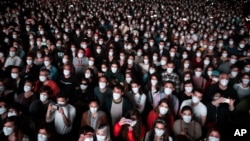 FILE - People using face masks attend a music concert in Barcelona, Spain, March 27, 2021. (AP Photo/Emilio Morenatti, File)