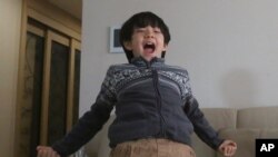 Parasite actor Jeong Hyeonjun celebrates as he watches a live broadcast of South Korean director Bong Joon Ho receiving the award for best original screenplay for "Parasite" at the Oscars, in Seoul, Feb. 10, 2020. 