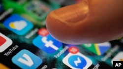 FILE - Various apps are seen on an iPhone in New Orleans, Aug. 11, 2019. U.S. military veterans who get medical care from the Veterans Health Administration will be able to access their health records on their Apple devices, the company said this week.