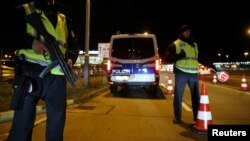German police are seen at a checkpoint to enter Berlin-Schoenefeld airport, in Schoenefeld, following a suspicion that a bomb attack was being planned in Germany, October 8, 2016.