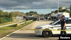 FILE - Police patrol the area outside Marjory Stoneman Douglas High School following a school shooting incident in Parkland, Florida, Feb. 15, 2018.