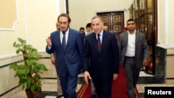 Iraq's new Defense Minister Khaled al-Obeidi (C) walks with acting Defense Minister Saadoun al-Dulaimi (L) at the Defense Ministry in Baghdad, Oct. 19, 2014.