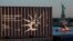 A container carrying a replica of the Statue of Liberty, left, passes in front of the full-sized Statue of Liberty as it arrives from France on a container ship in New York, June 30, 2021.