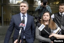 Michael Arnold, left, and Lissa Casey, attorneys representing Ammon Bundy, address the media covering the hearing of militia members outside United States District Court in Portland, Oregon, Jan. 27, 2016.