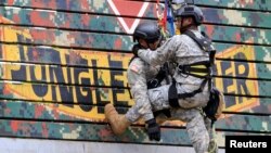 FILE - Members of the U.S. Army National Guard demonstrate rappelling skills during the Urban Search and Rescue activity of the 2016 RP-U.S. Balikatan joint military exercises in Camp Capinpin in Tanay, Rizal, east of Manila, Philippines, April 8, 2016. 