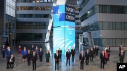 President Joe Biden and other NATO heads of the states and governments pose for a family photo during the NATO summit at the Alliance's headquarters, in Brussels, Belgium, where they also discuss increasingly tense relations with China and Russia.