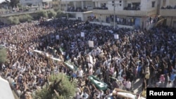 A man, holding a national flag with a poster of Turkey&#39;s founder Kemal Ataturk, watches as thousands of Turks clash with security as they try to break through barricades mounted around the prison and courthouse complex in Silivri, in the outskirts of Istanbul.