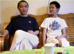 Chinese dissident Huang Qi is pictured with his son at their home in Chengdu, in southwest China's Sichaun province.